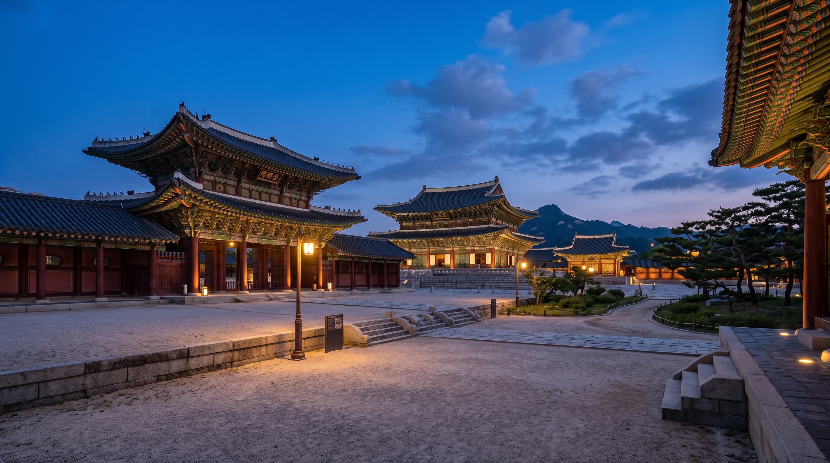 Seoul royal palace pavilions glowing under warm golden illumination at night
